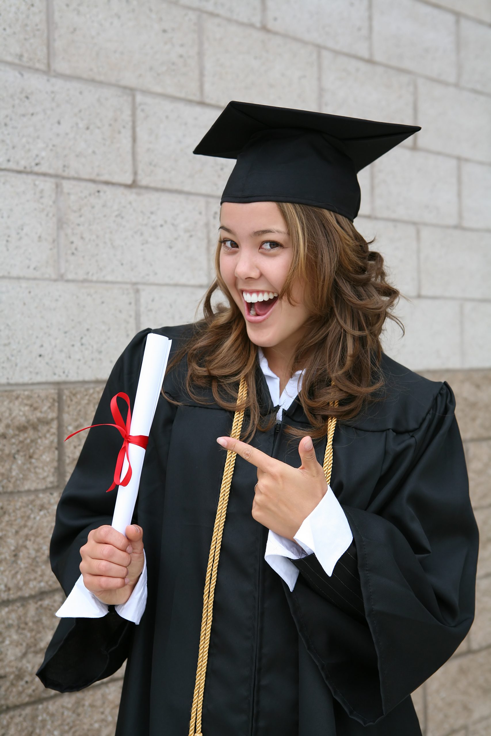 A pretty graduate celebrating her success with diploma